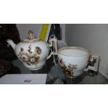 A C1790's Meissen porcelain bullet teapot decorated with hand painted flowers and highlighted with