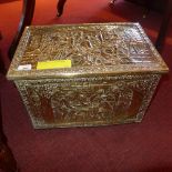 A brass clad log bin with scenes in relief