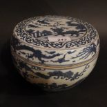 A Chinese lidded bowl decorated with mythical beasts and landscape reserves