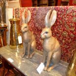 A pair of resin models of Hares