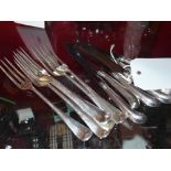 A set of six hallmarked silver handled pistol grip butter knives together with six silver plated