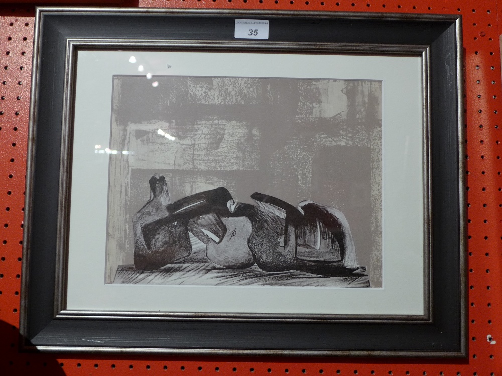 A Henry Moore lithograph of a reclining figure glazed and framed