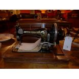 A vintage Frisster and Rossman sewing machine in oak case