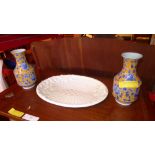 An Italian oval white glazed platter of basket design together with a pair of vases with flowers