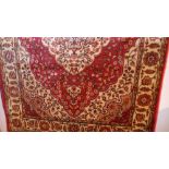 A Persian Kilim design runner the rouge field with extensive gold floral decoration in a triple