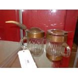 A moulded glass and planished copper lidded tankard and a similar (2)