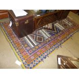 A Moroccan rug the blue ground with central pole medallion within multi border