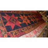 A hand knotted Kazak runner the pole medallion centre within triple border