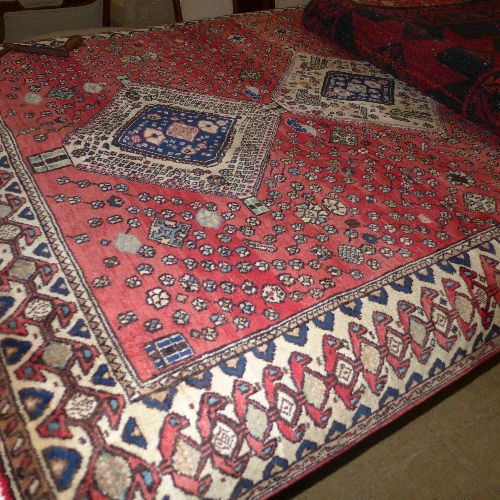 An Agra design carpet the terracotta ground with floral decoration