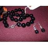 A faceted agate necklace with earrings. 16mm beads
