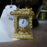 An ornate gilted miniature clock