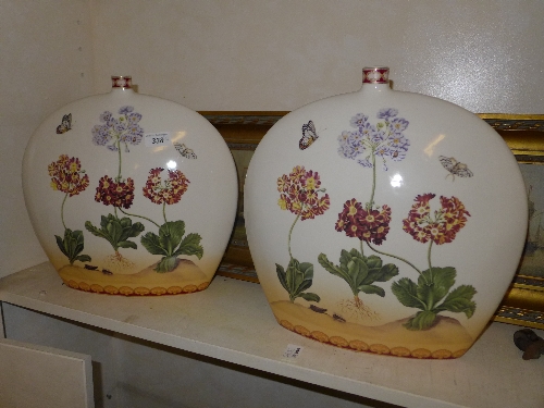 A pair of moon flask vases with floral a