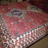 An Agra design carpet the terracotta ground with floral decoration