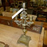 A pair of brass four sconce candelabra raised on paw feet