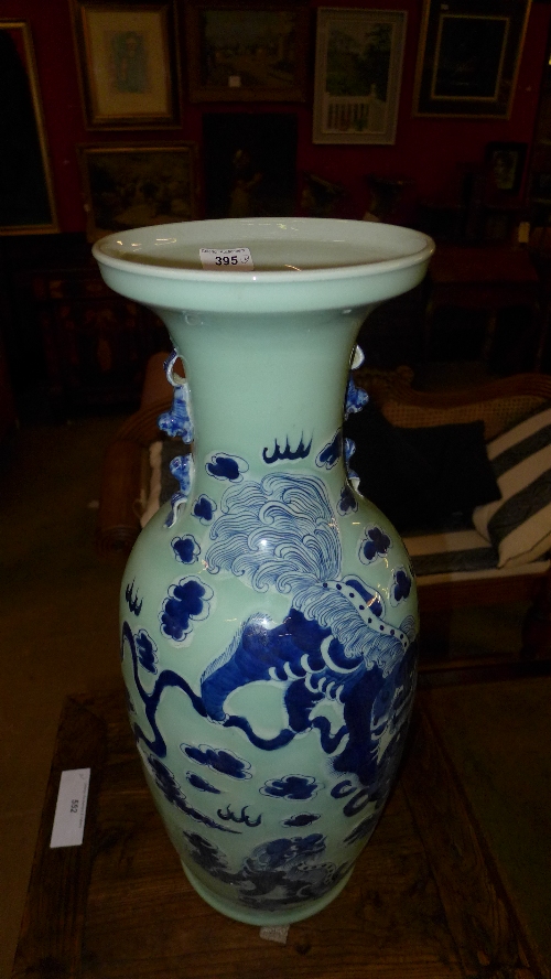 A large pair of Chinese celadon porcelain vases with dragon detail