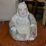 A porcelain figure of a seated Buddha