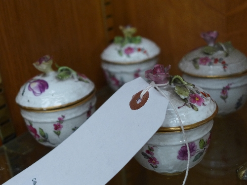 A Meissen set of four porcelain cups and cover with hand painted floral decoration