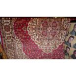 A Persian Kilim design carpet the rouge field with central pendant motifs and extensive gold