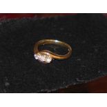 A ladies 9ct gold and diamond crossover ring