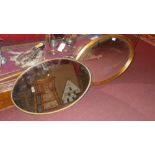 An oval gilt framed mirror and a similar (2)