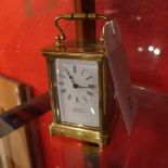 A brass carriage clock by Arnsby Goldsmiths Northampton with bevelled glazed panels and Roman