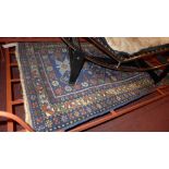A Persian flatweave rug the dark blue ground decorated with repeating motifs in a triple border