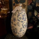A pair of white glazed and lidded jars decorated with blue flowers