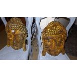 A pair of rustic wall hanging Buddha faces