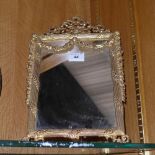 A neo-classical design gilt metal ladies boudoir mirror with ribbon and swag relief