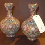 A pair of Chinese cloisonne vases of baluster form decorated with polychrome flowers