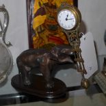 A cast metal elephant form clock with swinging movement