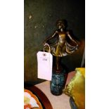 A bronzed ballerina on a marble stand