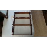 A four tiered mahogany open wall hanging shelves