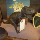 A bronzed figure of a dinosaur
