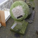 A pair of stone garden spherical statues