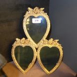 A gilded heart shaped triple photo frame