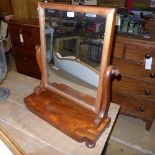 A Victorian mahogany dressing swing mirror on bun feet