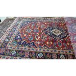 A fine central Persian Kashan rugs 150 cm x 100 cm, central floral medallion on a rouge field within