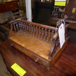 A late Victorian walnut desk tidy/bookshelf twin drawers on bun feet