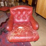 A near pair of late Victorian gentleman's armchairs ( possible Howard)upholstered in red button