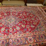 A fine central Persian Kashan rug 143 cm x 95 cm central floral medallion on a rouge field within