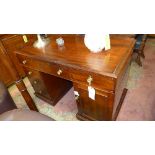 An early Victorian mahogany kneehole desk the three drawers above an arrangement of drawers and
