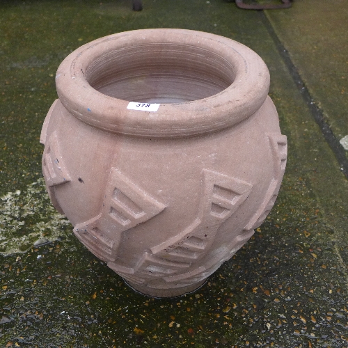 A carved stone garden planter