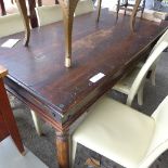 An Indian teak dining table with wrought iron mounts