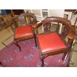 A near pair of Victorian mahogany corner chairs with splat backs and red leather drop-in seats