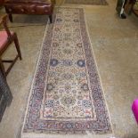 A hand knotted Agra runner with beige field and floral decoration
