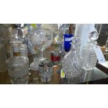 A collection of glassware including decanters, oversized wine glass, cruet and others