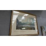 A C19th watercolour lakescape with building and figure in the fore framed and glazed