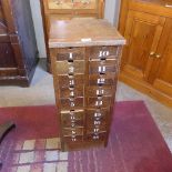 An oak collectors cabinet with eighteen drawers