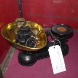 A set of grocers scales and a collection of brass weights
